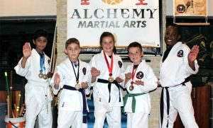 Sarthak Akole (two silvers for forms and sparring), Liam Pearson (gold for sparring), Janne van Heerden (bronze in forms), Xander van Heerden (bronze in forms) and Exoce Kadiya from the Cresta Club enjoy a photo after the championships. Photo: Supplied
